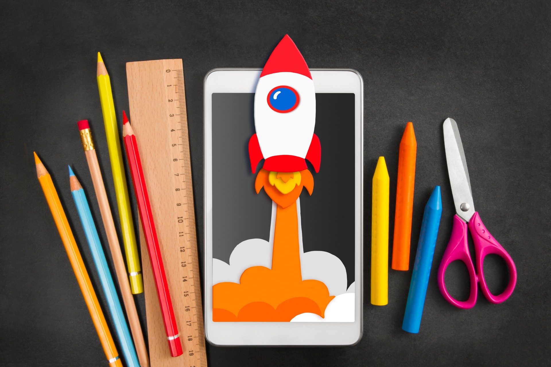 Rocket Drawing in Digital Tablet with School Supplies